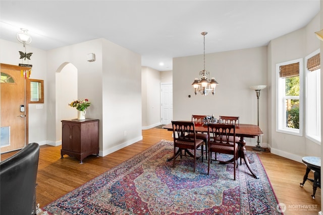 3319 Sunny Cove Ct, Bellingham, WA 98226 - dining space with arched walkways, wood finished floors, a chandelier, and recessed lighting