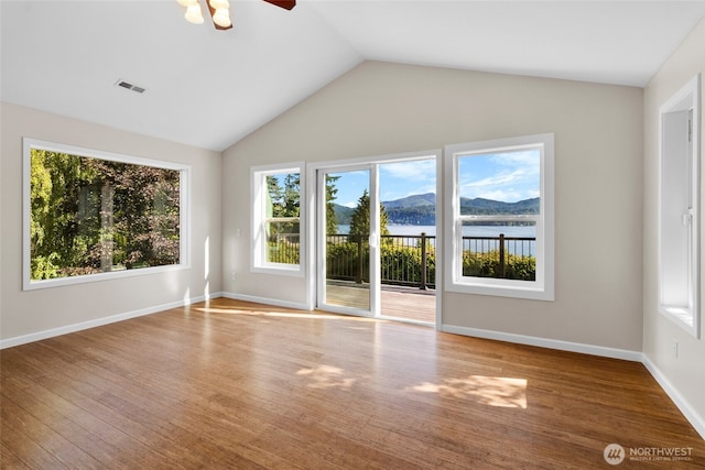 3319 Sunny Cove Ct, Bellingham, WA 98226 - unfurnished room featuring plenty of natural light, lofted ceiling, ceiling fan, and wood finished floors