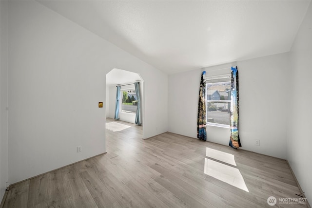 1809 Heritage Hvn, Wenatchee, WA 98801 - spare room with arched walkways, light wood-style flooring, and lofted ceiling