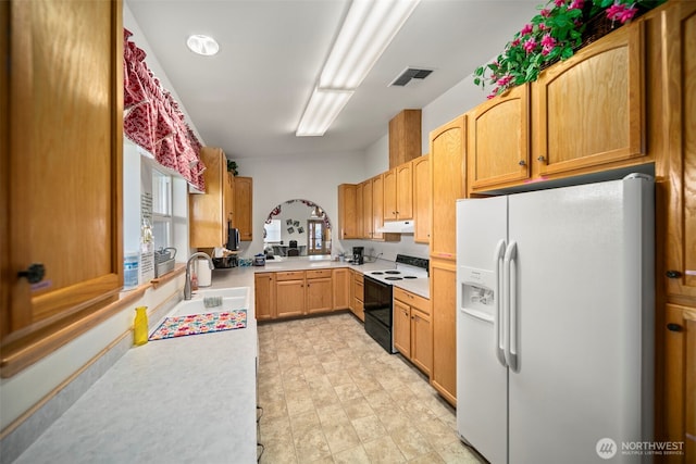 1809 Heritage Hvn, Wenatchee, WA 98801 - kitchen with white refrigerator with ice dispenser, black range with electric stovetop, under cabinet range hood, and light countertops