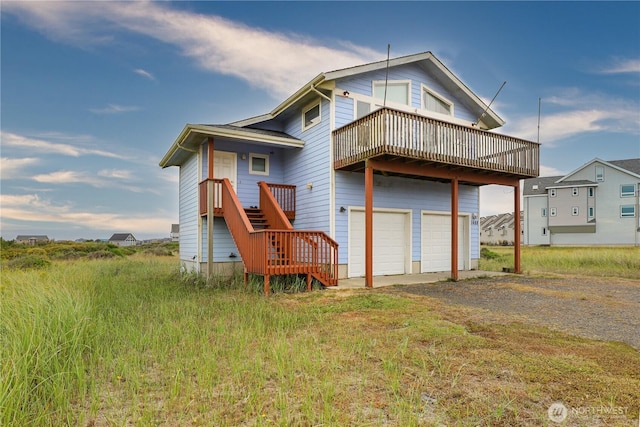 1488 Ocean Shores Blvd SW, Ocean Shores, WA 98569 - back of property featuring gravel driveway, a garage, and stairs