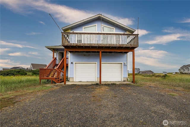 1488 Ocean Shores Blvd SW, Ocean Shores, WA 98569 - view of front of house featuring gravel driveway, a garage, stairs, and a wooden deck
