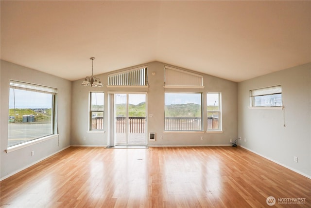 1488 Ocean Shores Blvd SW, Ocean Shores, WA 98569 - empty room with a chandelier, plenty of natural light, light wood-type flooring, and lofted ceiling