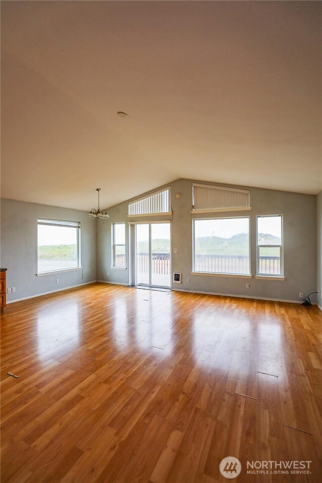 1488 Ocean Shores Blvd SW, Ocean Shores, WA 98569 - spare room featuring lofted ceiling, a chandelier, and light wood-style flooring