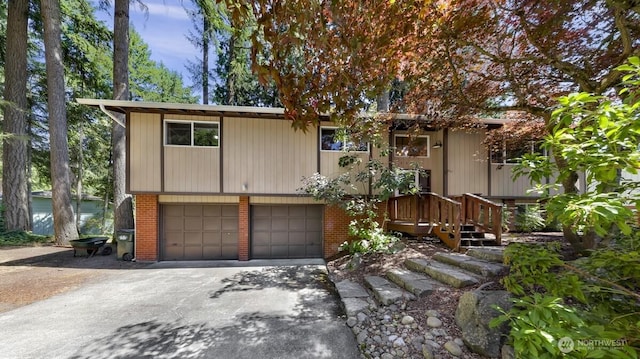 4402 Clearwater Dr SE, Lacey, WA 98503 - bi-level home featuring concrete driveway, a garage, and brick siding