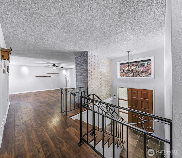 4402 Clearwater Dr SE, Lacey, WA 98503 - corridor featuring a textured ceiling, an upstairs landing, wood finished floors, and a chandelier