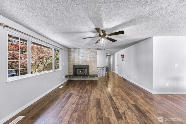 4402 Clearwater Dr SE, Lacey, WA 98503 - unfurnished living room with ceiling fan, dark wood-style flooring, and a textured ceiling