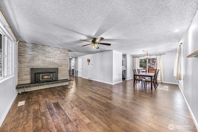 4402 Clearwater Dr SE, Lacey, WA 98503 - living area with ceiling fan, wood-type flooring, a textured ceiling, and a fireplace