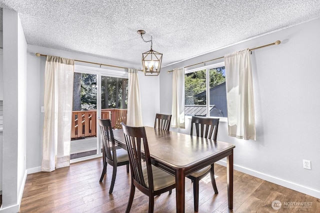 4402 Clearwater Dr SE, Lacey, WA 98503 - dining room with a textured ceiling, hardwood / wood-style flooring, and a chandelier