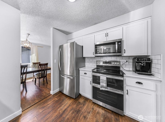 4402 Clearwater Dr SE, Lacey, WA 98503 - kitchen with stainless steel appliances, light countertops, a textured ceiling, tasteful backsplash, and white cabinetry