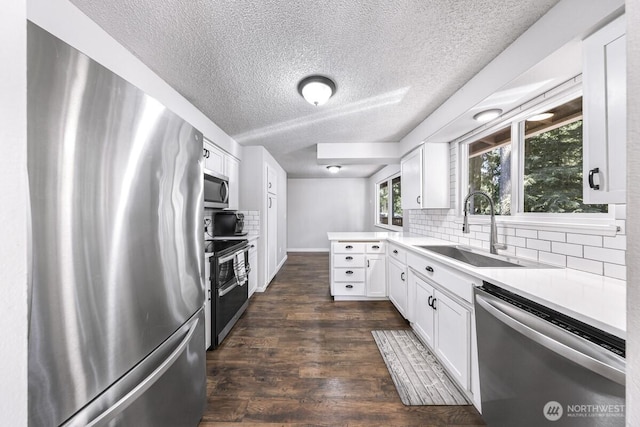 4402 Clearwater Dr SE, Lacey, WA 98503 - kitchen featuring appliances with stainless steel finishes, tasteful backsplash, a textured ceiling, a peninsula, and light countertops