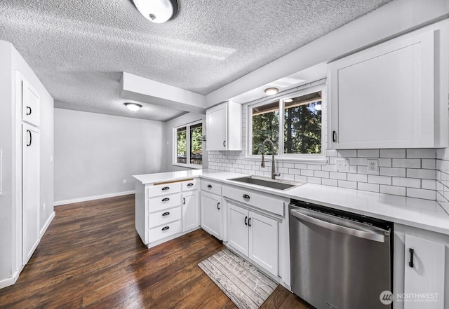 4402 Clearwater Dr SE, Lacey, WA 98503 - kitchen with stainless steel dishwasher, a peninsula, backsplash, light countertops, and a textured ceiling