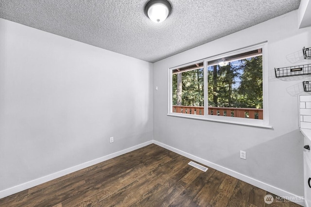 4402 Clearwater Dr SE, Lacey, WA 98503 - empty room featuring dark wood-style floors and a textured ceiling