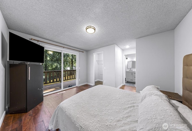 4402 Clearwater Dr SE, Lacey, WA 98503 - bedroom featuring access to exterior, wood finished floors, a textured ceiling, and connected bathroom