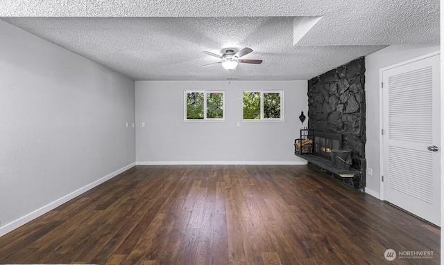 4402 Clearwater Dr SE, Lacey, WA 98503 - unfurnished living room with ceiling fan, wood finished floors, a textured ceiling, and a stone fireplace