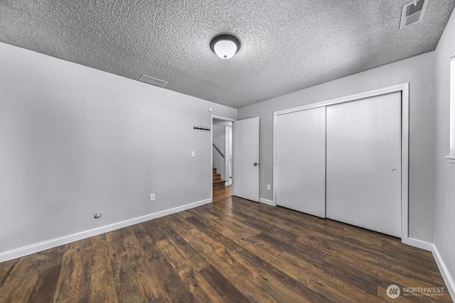 4402 Clearwater Dr SE, Lacey, WA 98503 - unfurnished bedroom with wood finished floors, a textured ceiling, and a closet