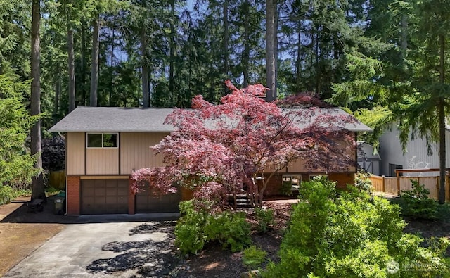 4402 Clearwater Dr SE, Lacey, WA 98503 - view of front of house featuring an attached garage, concrete driveway, stairway, brick siding, and roof with shingles