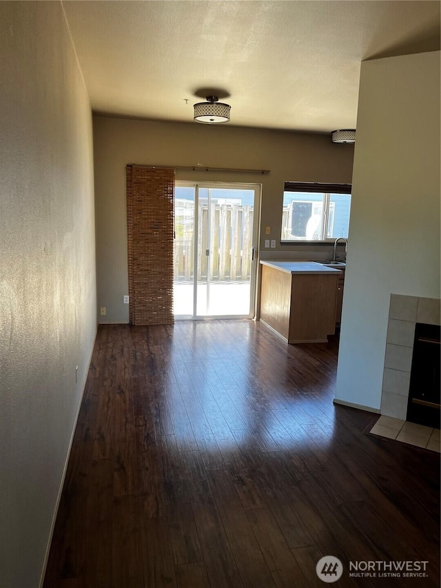 6304 Barstow Ln SE Unit 7, Lacey, WA 98513 - unfurnished living room featuring dark wood-type flooring and a sink