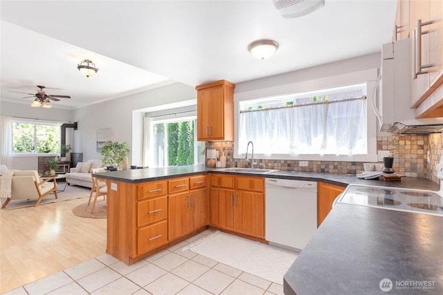 2427 Lincoln St, Bellingham, WA 98225 - kitchen with white appliances, a peninsula, backsplash, open floor plan, and dark countertops
