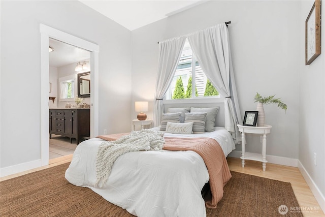 2427 Lincoln St, Bellingham, WA 98225 - bedroom featuring multiple windows, light wood-style floors, and ensuite bathroom