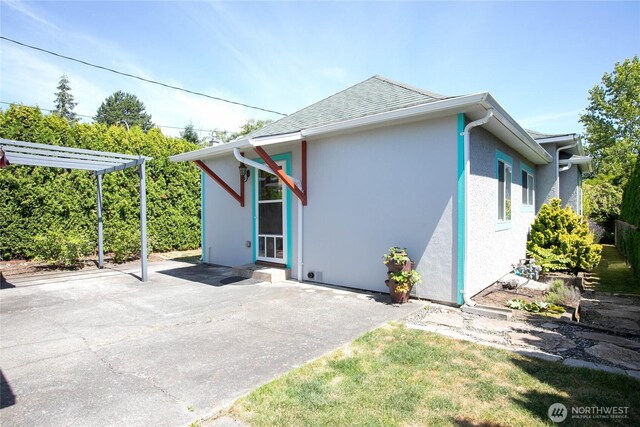 2427 Lincoln St, Bellingham, WA 98225 - back of house with stucco siding, a patio, and roof with shingles