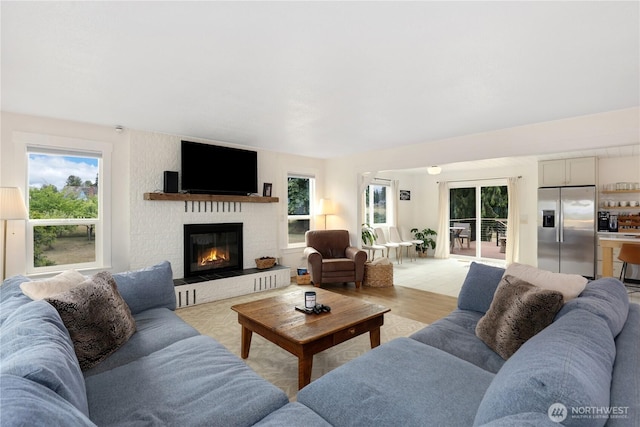 11112 234th St E, Graham, WA 98338 - living room with plenty of natural light, a brick fireplace, and light wood-type flooring