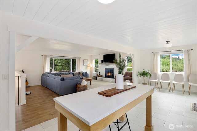 11112 234th St E, Graham, WA 98338 - living area featuring a glass covered fireplace and light tile patterned floors