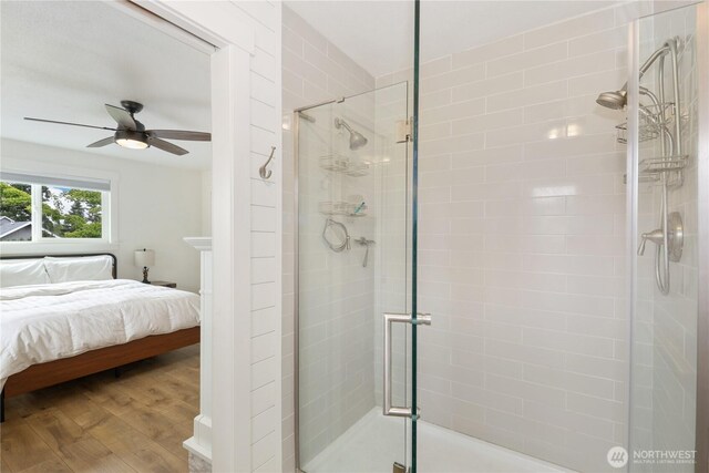 11112 234th St E, Graham, WA 98338 - ensuite bathroom with a stall shower, a ceiling fan, and wood finished floors