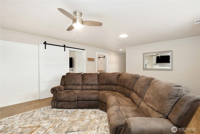 11112 234th St E, Graham, WA 98338 - living area featuring a ceiling fan, wood finished floors, a barn door, and recessed lighting
