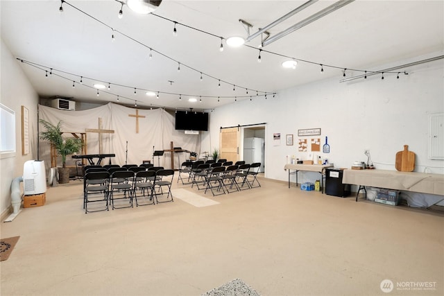 11112 234th St E, Graham, WA 98338 - miscellaneous room with finished concrete flooring, a barn door, and an AC wall unit