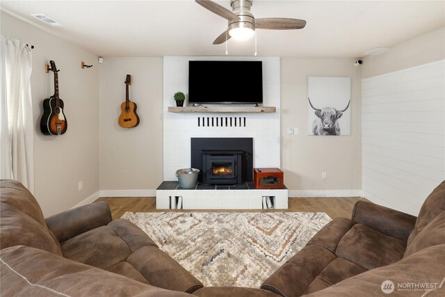 11112 234th St E, Graham, WA 98338 - living room with wood finished floors, ceiling fan, and a fireplace