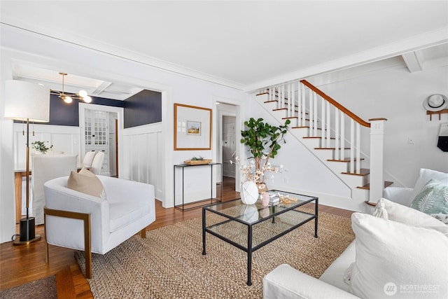 7016 Fremont Ave N, Seattle, WA 98103 - living area with wood finished floors, stairs, wainscoting, beam ceiling, and a decorative wall