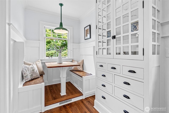 7016 Fremont Ave N, Seattle, WA 98103 - dining area with breakfast area, ornamental molding, dark wood finished floors, wainscoting, and a decorative wall