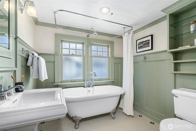 7016 Fremont Ave N, Seattle, WA 98103 - bathroom with a decorative wall, a soaking tub, a wainscoted wall, tile patterned flooring, and a shower with curtain