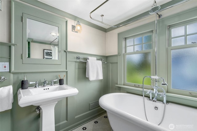 7016 Fremont Ave N, Seattle, WA 98103 - bathroom featuring a freestanding bath and tile patterned flooring