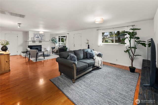 204 Duvall Ave SE, Renton, WA 98059 - living room with plenty of natural light, a glass covered fireplace, and wood finished floors
