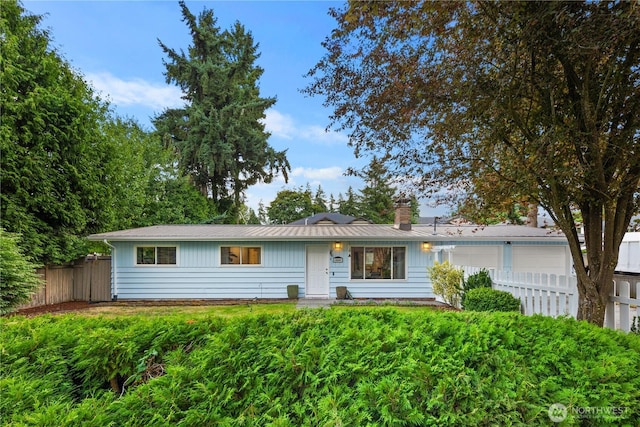 204 Duvall Ave SE, Renton, WA 98059 - ranch-style home featuring an attached garage, a chimney, and a metal roof
