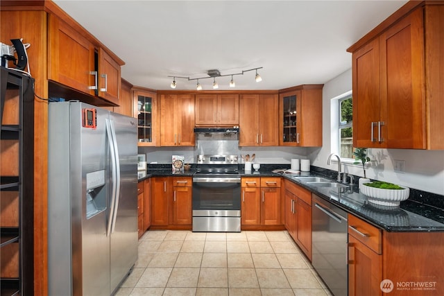 204 Duvall Ave SE, Renton, WA 98059 - kitchen with appliances with stainless steel finishes, brown cabinetry, under cabinet range hood, and light tile patterned floors