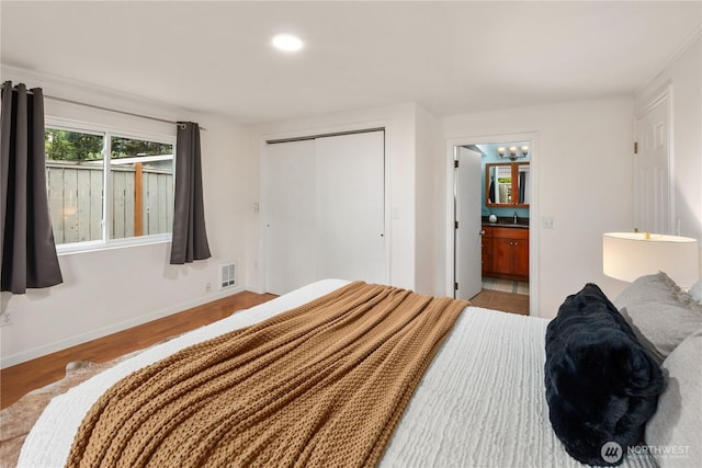 204 Duvall Ave SE, Renton, WA 98059 - bedroom featuring a closet, ensuite bath, wood finished floors, a chandelier, and recessed lighting