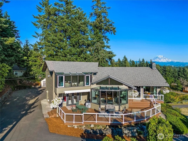 18110 85th St E, Bonney Lake, WA 98391 - rear view of property with roof with shingles, a chimney, and a mountain view