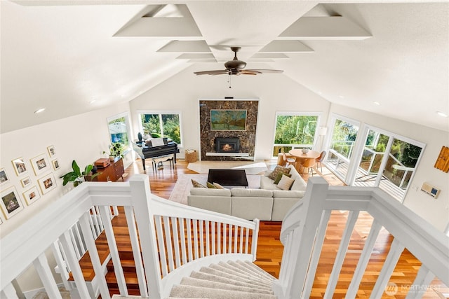 18110 85th St E, Bonney Lake, WA 98391 - living area with wood finished floors, a high end fireplace, healthy amount of natural light, a ceiling fan, and lofted ceiling