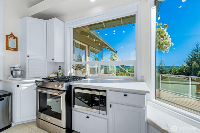 18110 85th St E, Bonney Lake, WA 98391 - kitchen featuring appliances with stainless steel finishes, white cabinetry, light countertops, and light tile patterned flooring