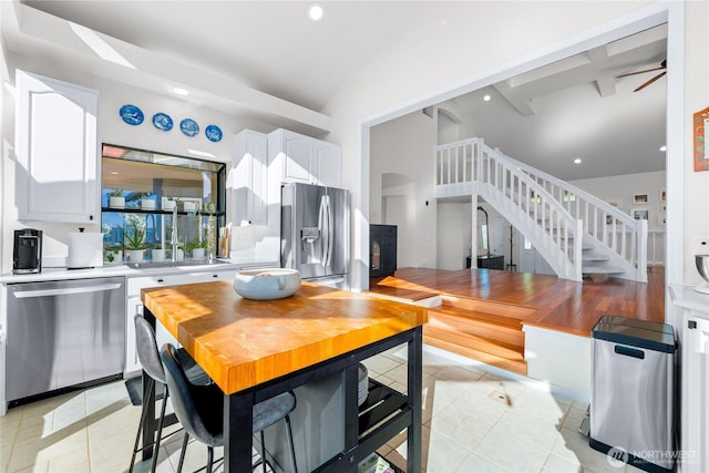 18110 85th St E, Bonney Lake, WA 98391 - dining area with stairway, light tile patterned floors, recessed lighting, vaulted ceiling, and arched walkways