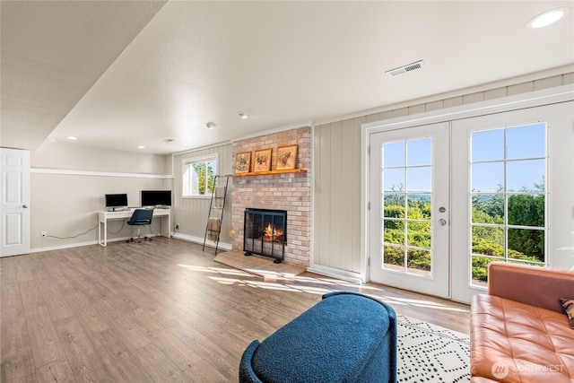 18110 85th St E, Bonney Lake, WA 98391 - living room featuring a desk, wood finished floors, a brick fireplace, recessed lighting, and french doors