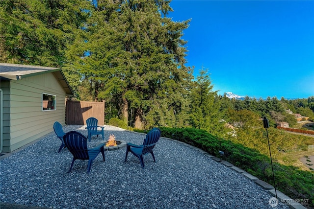 18110 85th St E, Bonney Lake, WA 98391 - view of patio featuring an outdoor fire pit and a wooded view