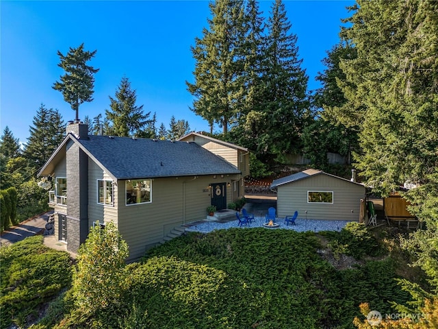 18110 85th St E, Bonney Lake, WA 98391 - rear view of property with a chimney and roof with shingles