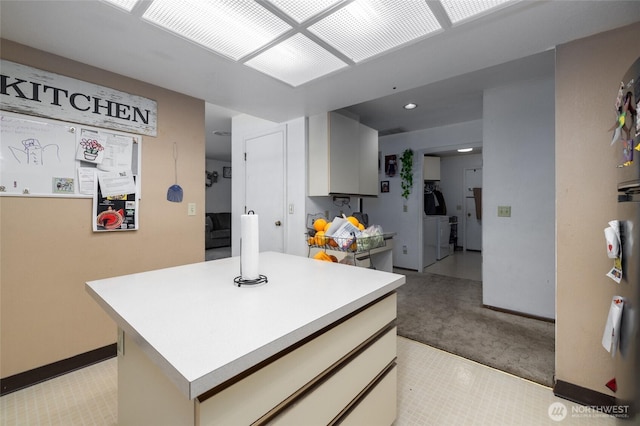 1710 E Highland Ave, Mount Vernon, WA 98273 - kitchen featuring light carpet, light countertops, recessed lighting, a center island, and washer / dryer