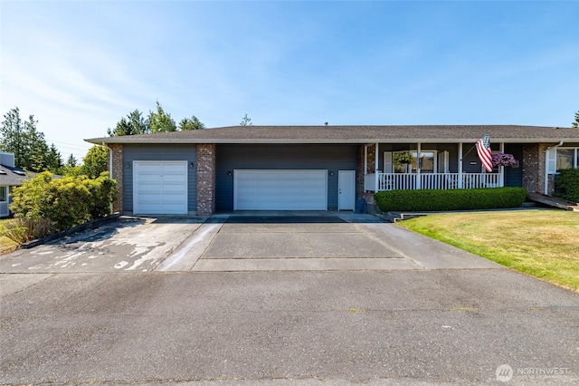 1710 E Highland Ave, Mount Vernon, WA 98273 - view of front of house with brick siding, a garage, driveway, and a porch