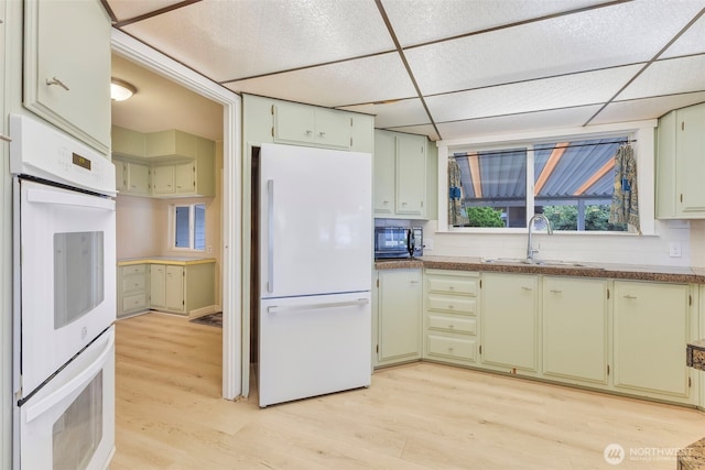 1402 22nd St NE Unit 86, Auburn, WA 98002 - kitchen featuring white appliances, light wood finished floors, a drop ceiling, and green cabinets