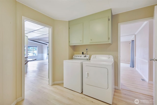 1402 22nd St NE Unit 86, Auburn, WA 98002 - laundry room featuring light wood-type flooring, washer and clothes dryer, and cabinet space